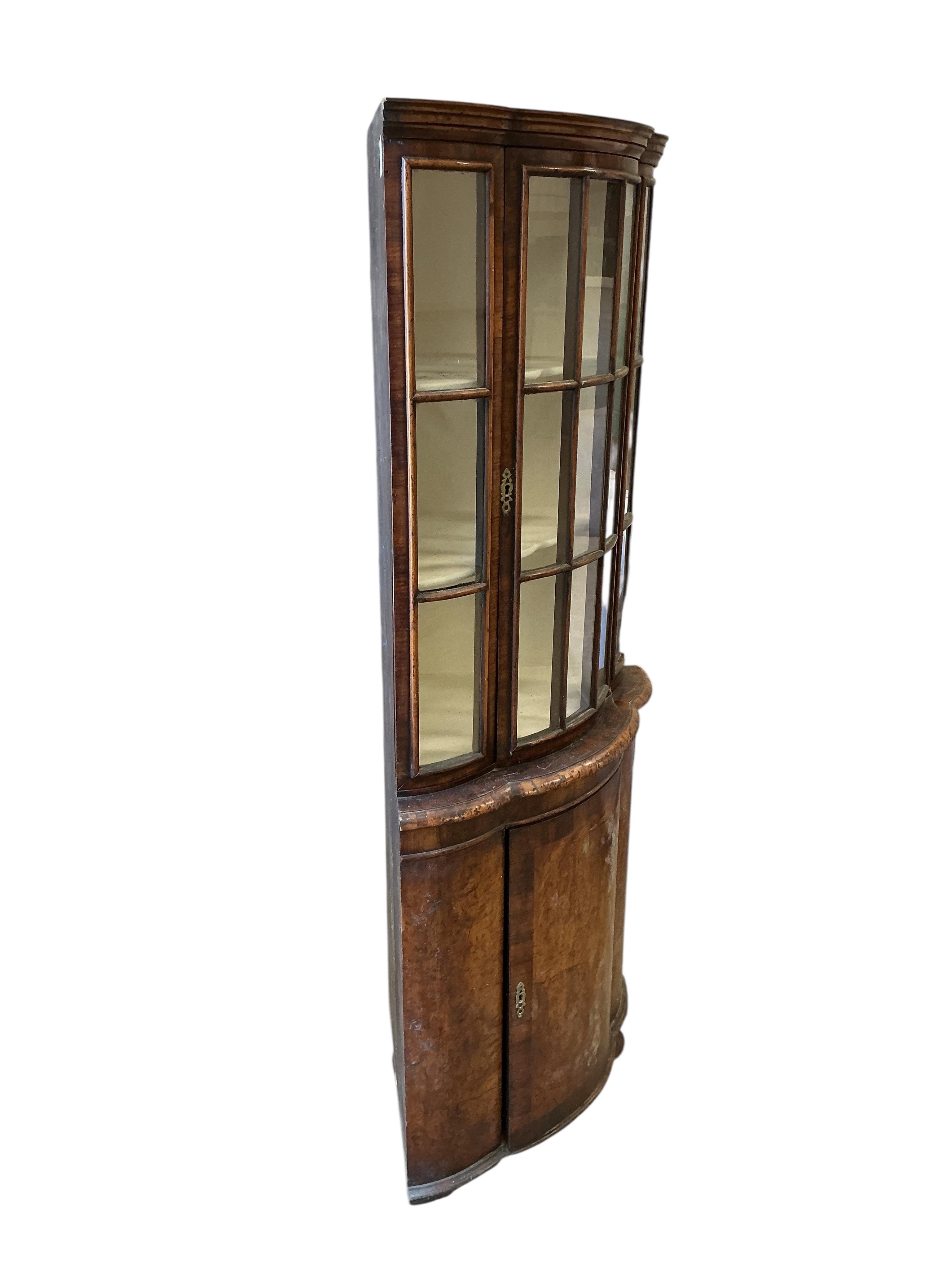 A Queen Anne Revival walnut bow front standing corner cupboard, width 68cm, depth 43cm, height 160cm